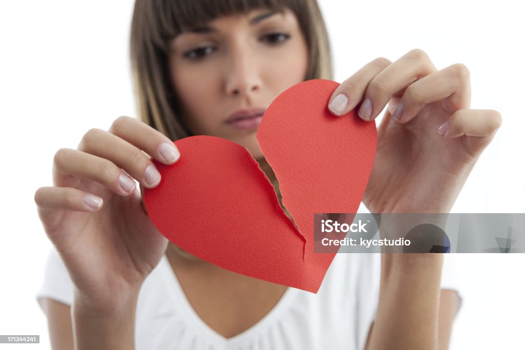 Broken Heart Girl Pensive Girl breaking a paper heart.See similars: Breaking Stock Photo