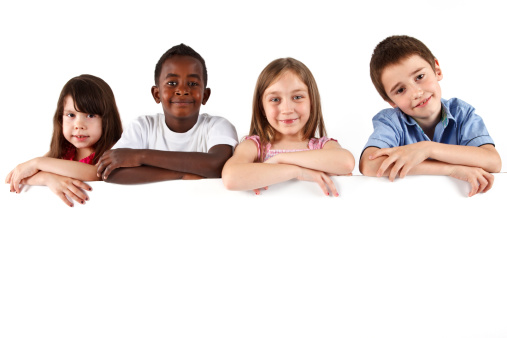 Group of children standing over a blank board. Isolated on a white background.