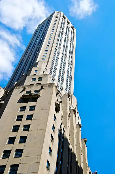 "A cityscape view of a modern classic and Art-Deco style 57 story high skyscraper seen in the Lower Manhattan Financial District. The structure was built in 1931 and known as the City Bank-Farmers Trust Building. It is now being used as a mixed commercial and residential building. Lower Manhattan, New York City."