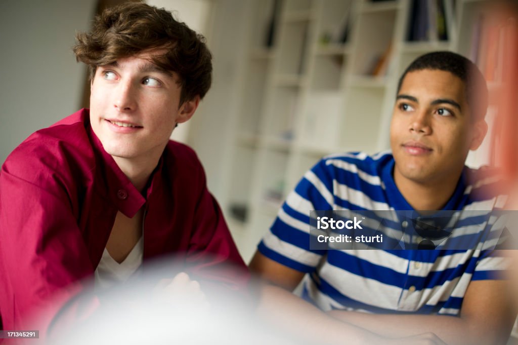 students in the study room three students in the seminar study room with their teacher Adolescence Stock Photo