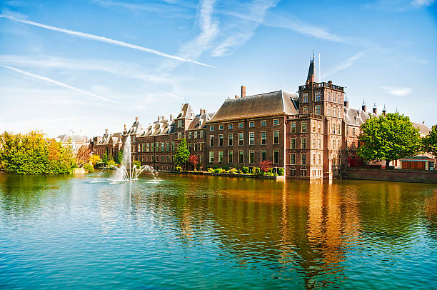 The Dutch Parliament in The Hague, Netherlands Binnenhof (Dutch Parliament), The Hague (Den Haag), The Netherlands. Visible are Historic buildings, art museum Mauritshuis along the pond Hofvijver, fountain and beautiful cloudscape over the reflection in the water. the hague stock pictures, royalty-free photos & images