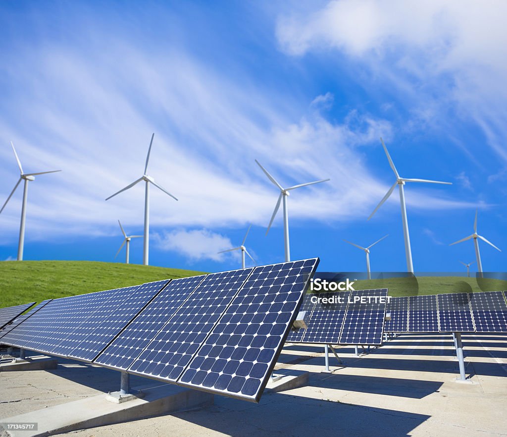 Solar Panels And Wind Turbines In A Green Field Solar Panels And Wind Turbines In A Green Field with blue skys. Solar Panel Stock Photo