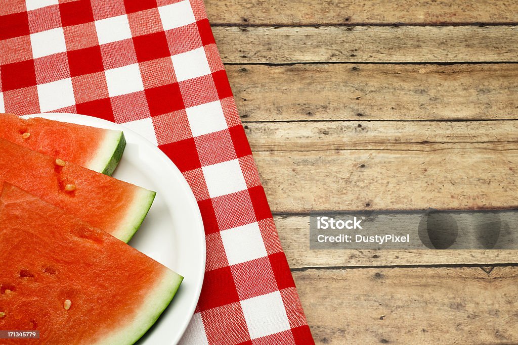 Summer Picnic Slices of watermelon on a picnic table with traditional red checked table cloth American Culture Stock Photo