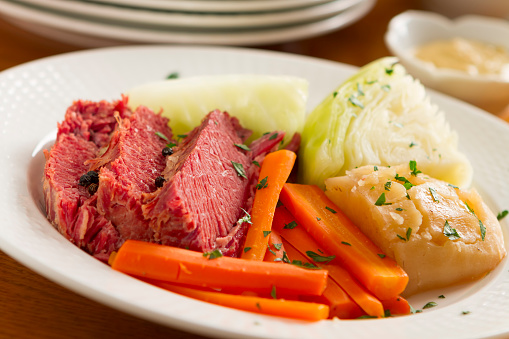 A classic boiled dinner of corned beef, cabbage, potatoes, onions, and carrots.