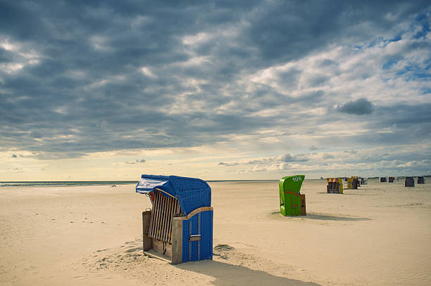 Beach chairs "Beachchairs on the beach with a huge sky, bit noise" amrum stock pictures, royalty-free photos & images