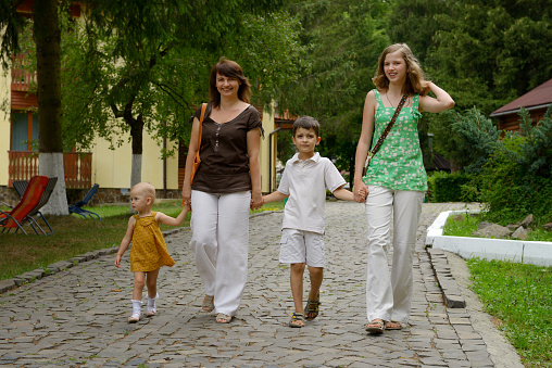 Mother with three children walking in a park