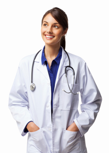 Happy young healthcare professional in lab coat with stethoscope around neck looking away. Vertical shot. Isolated on white.