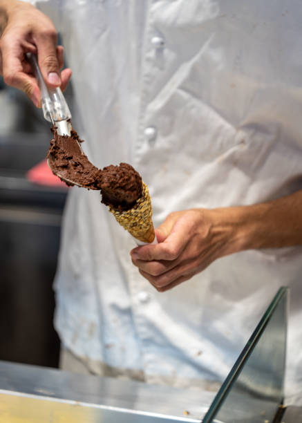 istock The hands of a master ice cream maker making chocolate ice cream 1713479569