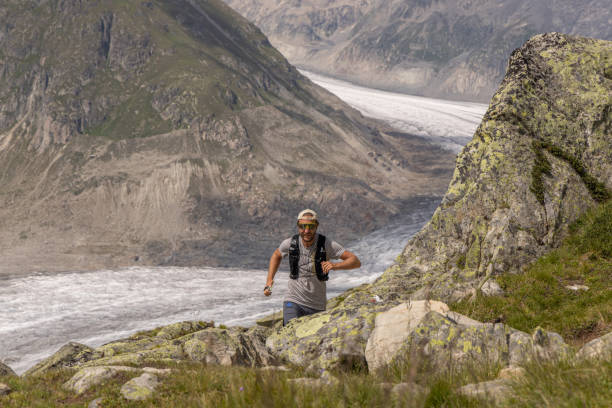 istock Trail runner ascends alpine path in Swiss mountain landscape 1713480139