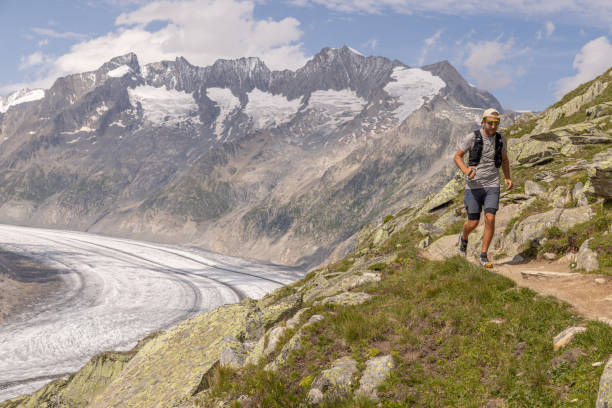 istock Trail runner ascends alpine path in Swiss mountain landscape 1713480676