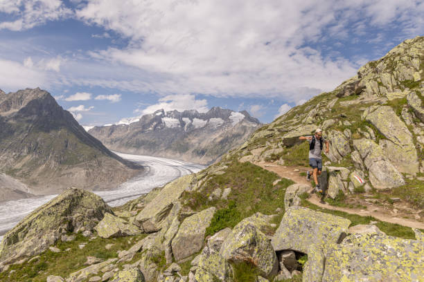 istock Trail runner ascends alpine path in Swiss mountain landscape 1713481222