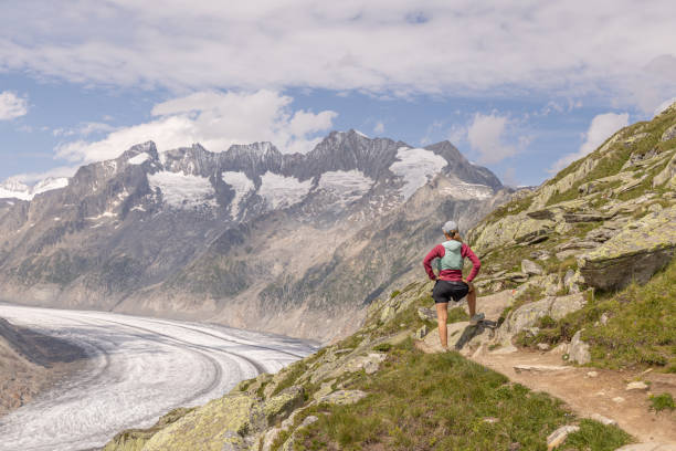 istock Female trail runner takes a break above glacier 1713481223
