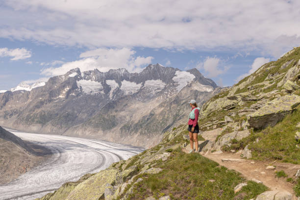istock Female trail runner takes a break above glacier 1713481228