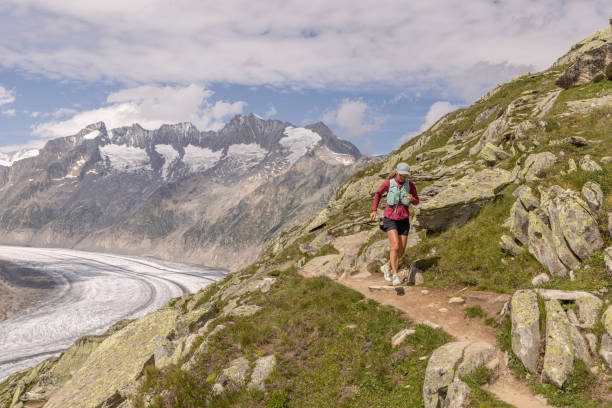 istock Female trail runner ascends alpine path in Swiss mountain landscape 1713481234