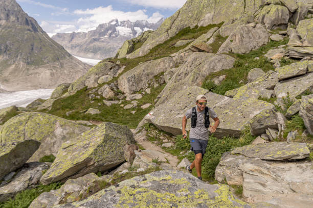 istock Trail runner bounds along mountain trail 1713482318