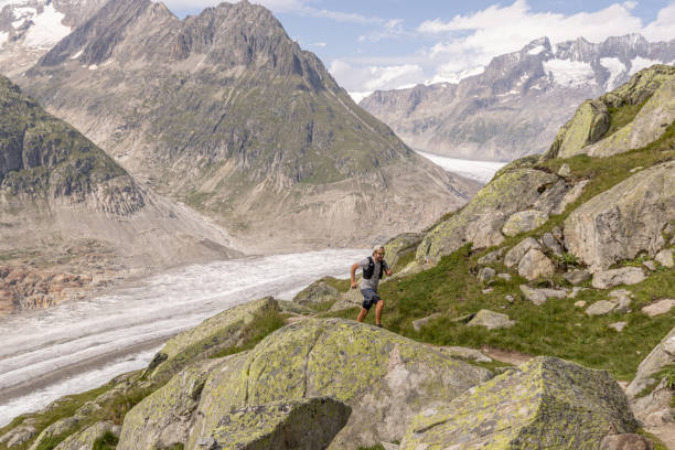 istock Trail runner ascends alpine path in Swiss mountain landscape 1713482319