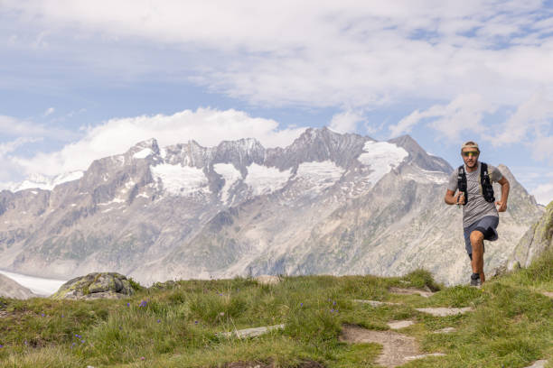 istock Trail runner ascends alpine path in Swiss mountain landscape 1713482320