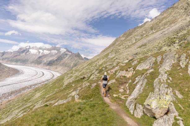 istock Trail runner ascends alpine path in Swiss mountain landscape 1713482390