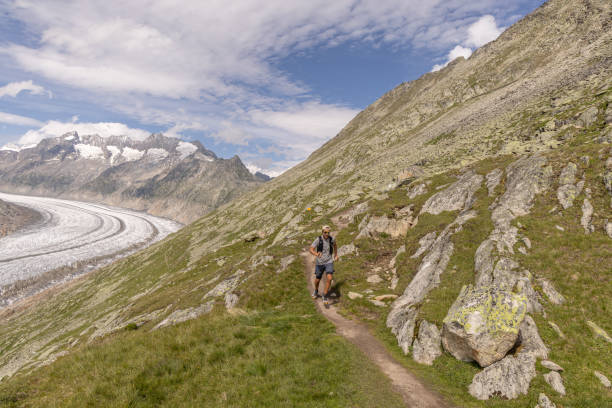 istock Trail runner ascends alpine path in Swiss mountain landscape 1713482536