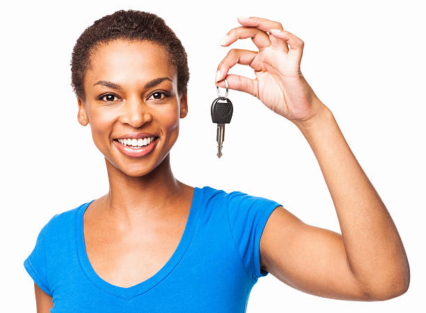 African American Woman Holding Car Key - Isolated Portrait of a beautiful African American woman holding car key. Horizontal shot. Isolated on white. car key photos stock pictures, royalty-free photos & images