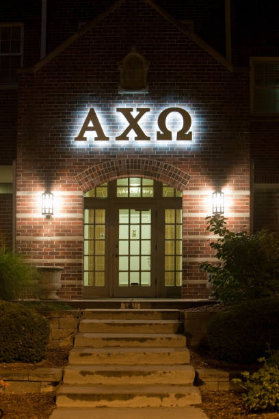 Alpha Chi Omega Sorority Entry and Sign "Lincoln, Nebraska, USA - July 26, 2012: Alpha Chi Omega sorority house main entrance door and illuminated sign, at night, located at 716 North 16th St., near the University of Nebraska campus." sorority photos stock pictures, royalty-free photos & images