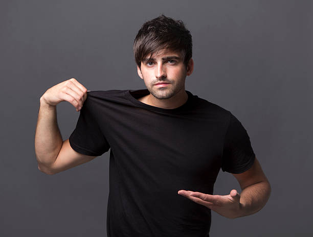 istock Handsome young man pointing at blank black shirt 171349091