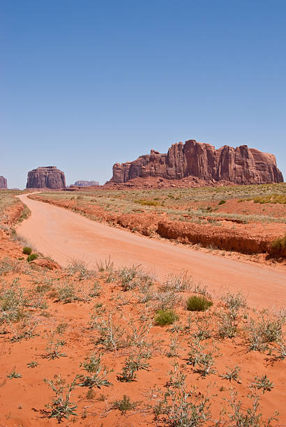 Dirt Road Leading to Merrick Butte A dirt road leads toward Merrick Butte at Monument Valley Tribal Park in Arizona, USA. jeff goulden monument valley stock pictures, royalty-free photos & images