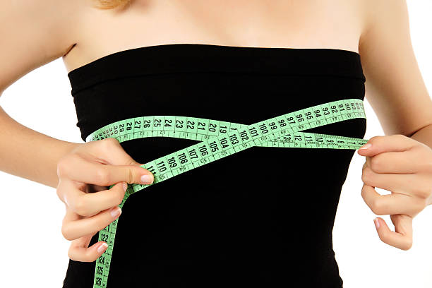 young woman is measuring her breast (XXXL) stock photo