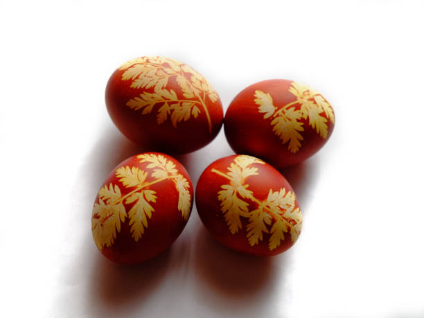 istock Painted Easter eggs on a white background. Floral pattern on a red eggshell. Festive food. 1713495700