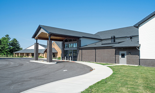 Drive and curved walkway to church portico entrance.