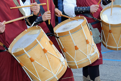 drum players with medieval clothes and ancient instruments during the historical re-enactment along the streets