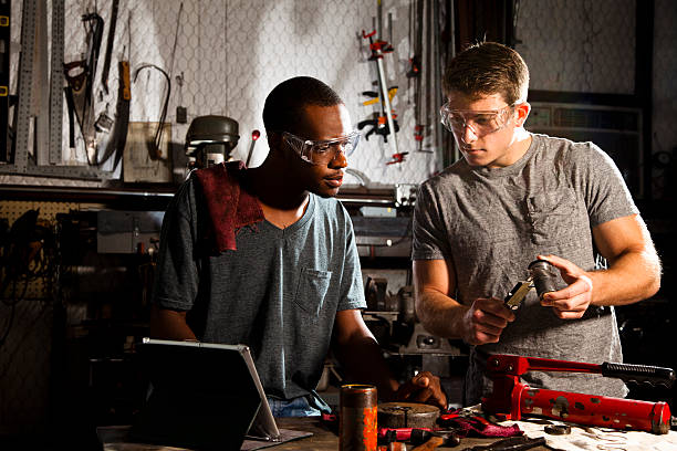 istock Two men at workbench using digital tablet to locate parts 171350080