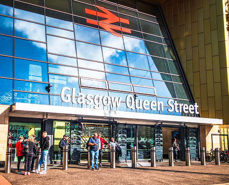 Glasgow, Scotland - People outside the entrance to Glasgow Queen Street railway station on George Square in Glasgow's city centre.