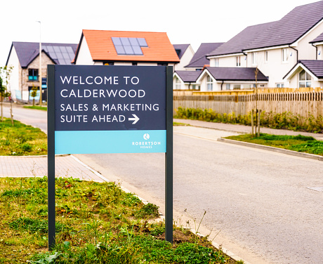 East Calder, UK - A sign for the sales and marketing suite for the Robertson Homes development at the Calderwood housing development in West Lothian, Scotland.