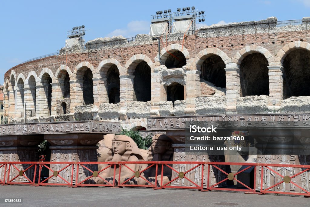 Verona Arena. "Verona, Italy - August 13, 2012: Verona Arena, with the props from the opera Aida moved outside and awaiting collection." Amphitheater Stock Photo