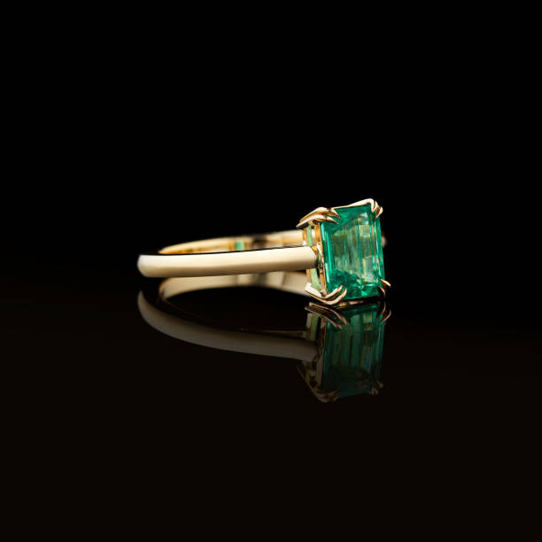 istock beautiful yellow gold ring with emerald on a black background 1713507376