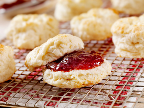 Homemade Buttermilk Biscuits Cooling on a rack in the Kitchen with Strawberry Jam- Photographed on Hasselblad H3D2-39mb Camera