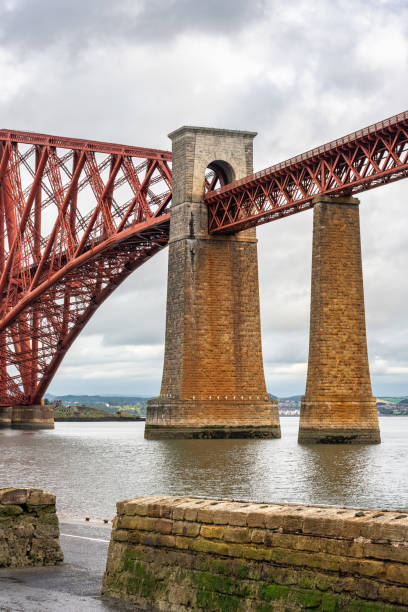 old red brick and metal bridge across the firth of forth in edinburgh, scotland. - firth of forth rail bridge bridge edinburgh europe imagens e fotografias de stock