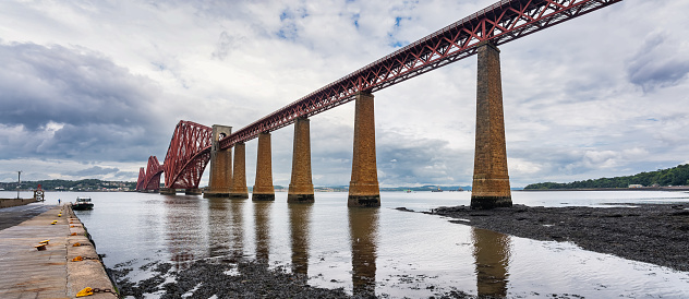 Old red brick and metal bridge across the Firth of Forth in Edinburgh, Scotland