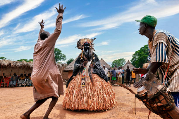 Celebration of dances and masks in the town of Godefouma in the Ivory Coast Godefouma village, Ivory Coast-appril 10-2022: Godefouma dances are a tribute to nature. Men dress up as different animals to worship nature. national park akan stock pictures, royalty-free photos & images