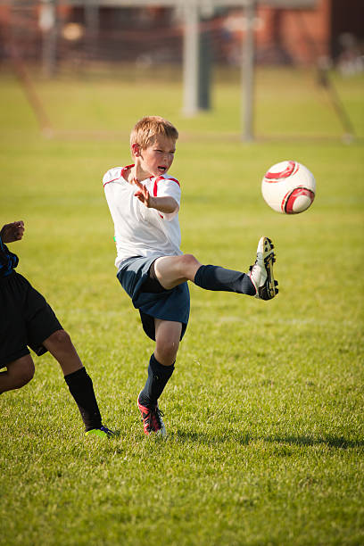 istock Young Child Soccer Player in Game Action 171352625