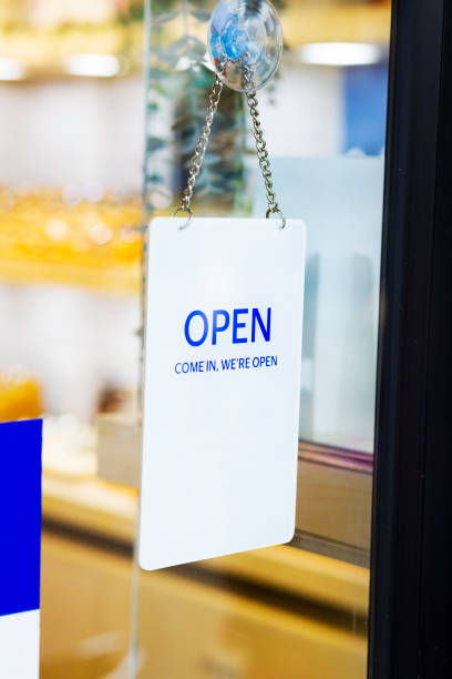 istock Hanging blue white open sign at glassy door 1713530837