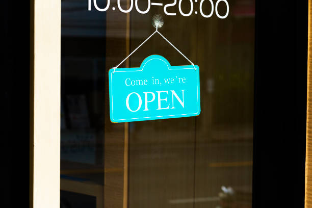 istock Turquoise colored open sign in door window 1713531349