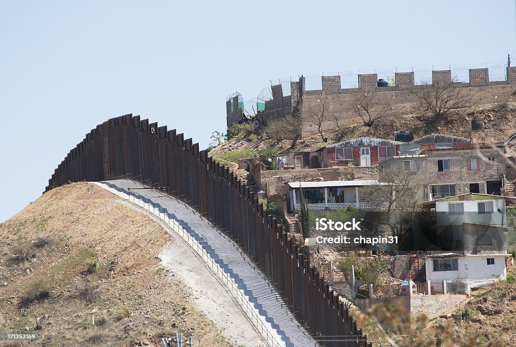 Border Fence in Nogales, Mexico "The new steel beam border fence overlooks Nogales, Mexico.  Since this section of new 18 foot tall fence has been completed in 2011, officials have cut the number of aliens entering the United States at this particular location drastically.  However, only 685 miles of the 2,100 miles of common border between Mexico and the US have been fenced, and much of that fence is useless barbed wire or chain link.  One mile of this new fencing costs from $1 million to $3 million dollars, and Arizona is using prison labor to cut down on costs. Fences will not totally deter illegal immigration - Nogales, for instance, is reputed to have more underground tunnels for smuggling people and drugs in the US than any other location along the border." Arizona Stock Photo