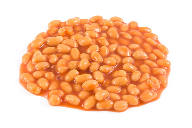 Baked Beans on a white background "Baked Beans isolated on white. Main focus toward the center of the heap, softer focus towards the edges." baked beans stock pictures, royalty-free photos & images