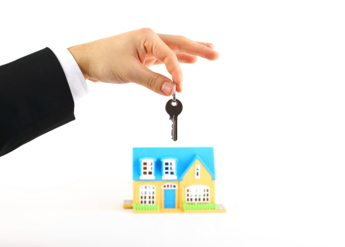 Businessman is  holding a house key