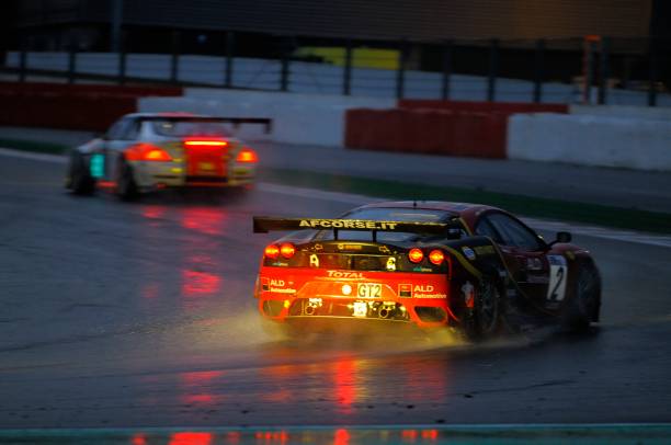 Ferrari F430 GT race car at the race track "Spa, Belgium - July 31, 2010: AF Corse Ferrari F430 racing on the track of Spa Francorchamps at night during the 2010 24 hours of Spa. The car is chasing a BMW B6 Alpina GT3." ferrari ferrari f430 italian culture action stock pictures, royalty-free photos & images