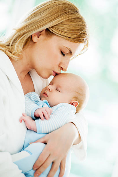 istock Mother holding her sleeping baby boy. 171354057