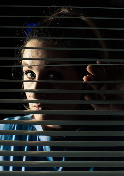 istock Woman looking trough window 171354108