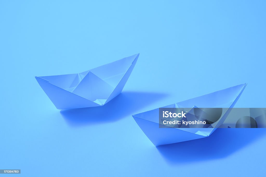 Blue tinted image of two paper boats with shadow Blue tinted image of two paper boats with shadow. Nautical Vessel Stock Photo